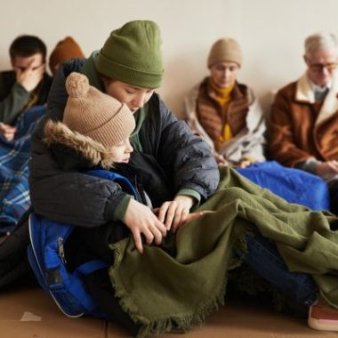 People gather on the floor of an evacuation center