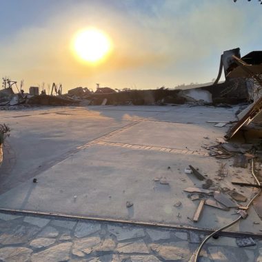 The aftermath of Jenny Yip's house in Pacific Palisades after the Palisades fire shows a hazy sun over a burned-out area with a slab of concrete.