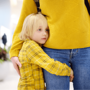 Child embracing mother anxiously.
