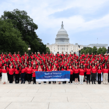Photo of a large group of high school students in red shirts. They are Bank of America Student Leaders in from of the nation's Capitol.