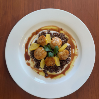A photo of Chef Jose Salazar's red quinoa with scallops and pomegranate sauce.