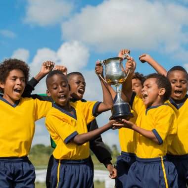 Image of boys sports teams holding up a trophy.