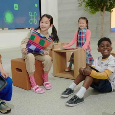 Children 8-12 attend an Apple summer camp. They are holding iPads.