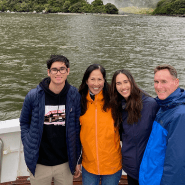 A family of four with, from left to right, a teen son, mother, teen daughter and father.